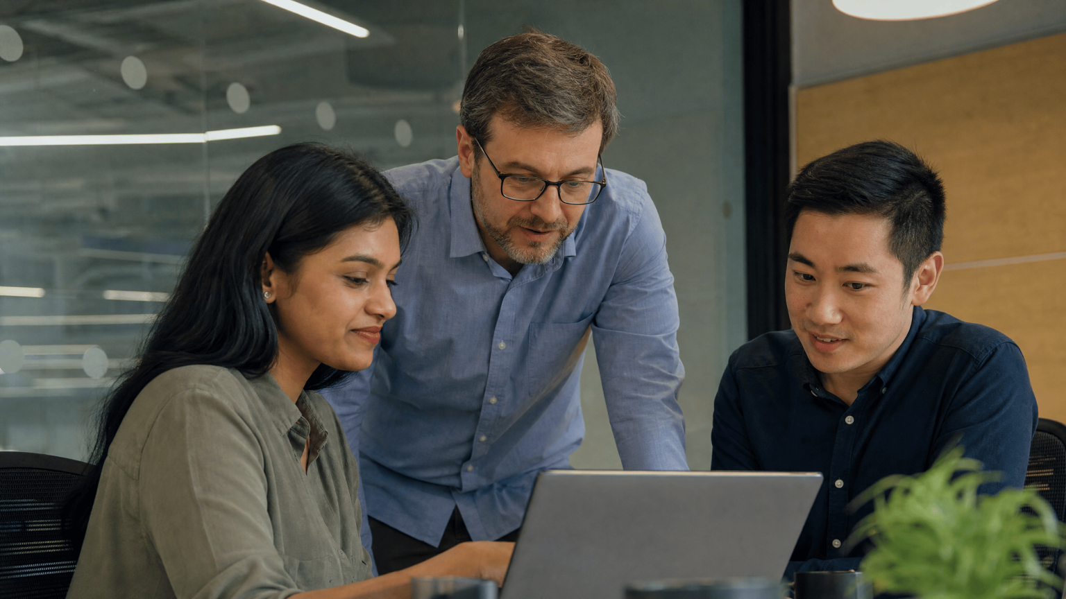 A small IT and compliance team reviewing security and regulatory status together